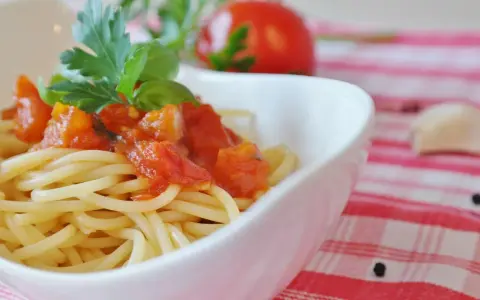 Spaghetti mit einem frischen Sugo di Pomodoro, garniert mit Basilikum und Petersilie. Ein Hauch von Italien auf dem Teller.