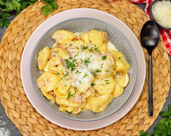 Schmackhafte Tortellini in cremiger Sauce, bestreut mit Parmesan und Petersilie. Perfekt, wenn man sich fragt, welche Sauce zu Tortellini passt.