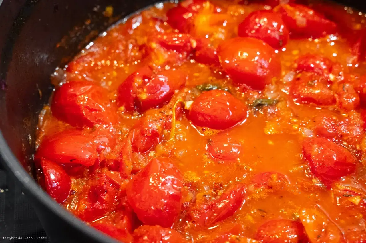 Ein köstliches Sugo-Rezept mit vielen saftigen Tomaten, die in einem Topf köcheln.